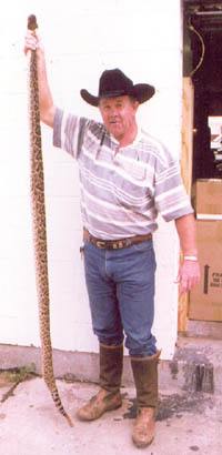 Butch Thompson holding a 7 foot Diamondback Rattlesnake